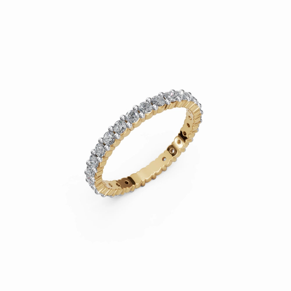 Yellow gold eternity ring photographed at 45°, emphasizing radiant gold color and elegant brilliance.