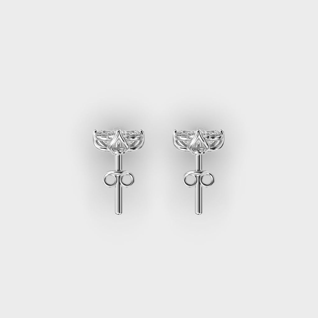 Top view of white gold floral cluster earrings featuring six lab grown diamonds in a petal-inspired layout.