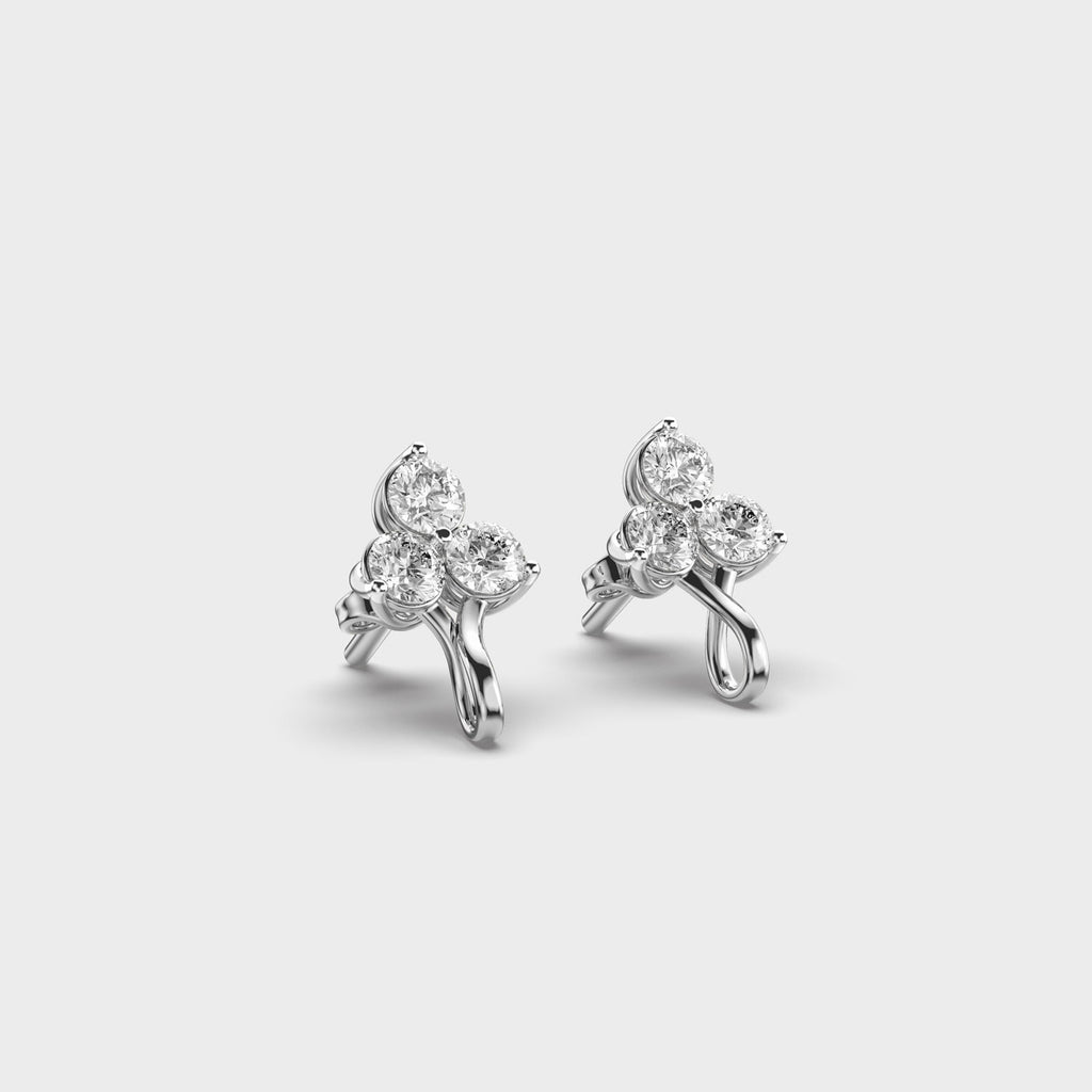 White gold diamond earrings seen from the top-side angle, highlighting the twisted stem and clustered sparkle.