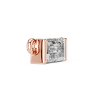 Rose gold charm with a clear gemstone on a white background