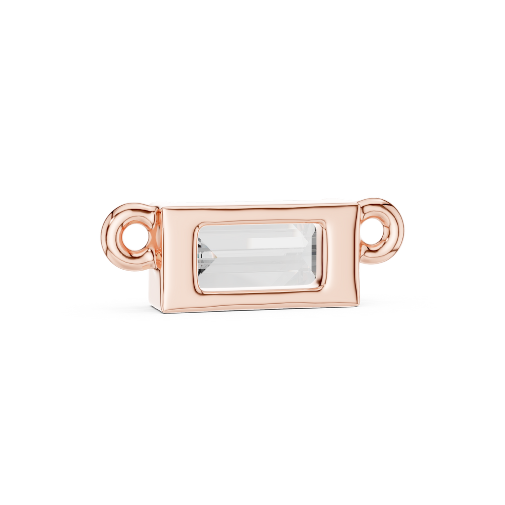 Rose gold jewelry clasp with a clear gemstone on a white background