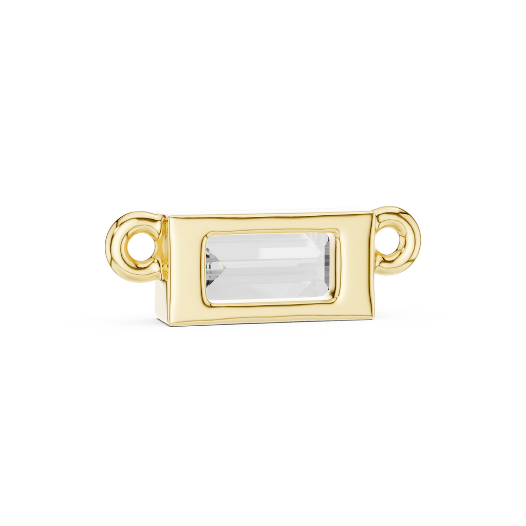 Gold jewelry clasp with a clear gemstone on a white background