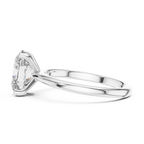 Side angle of oval solitaire diamond ring in white gold showing sleek band and setting