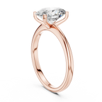 Top view of oval solitaire diamond ring in rose gold focusing on shimmering center stone