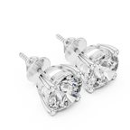 White gold solitaire diamond stud earrings top view displaying precision-set round brilliant diamonds and balanced prong alignment