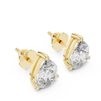 Gold earrings with clear gemstones on a white background