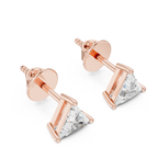 Side angle of yellow gold trillion diamond stud earrings showing clean setting