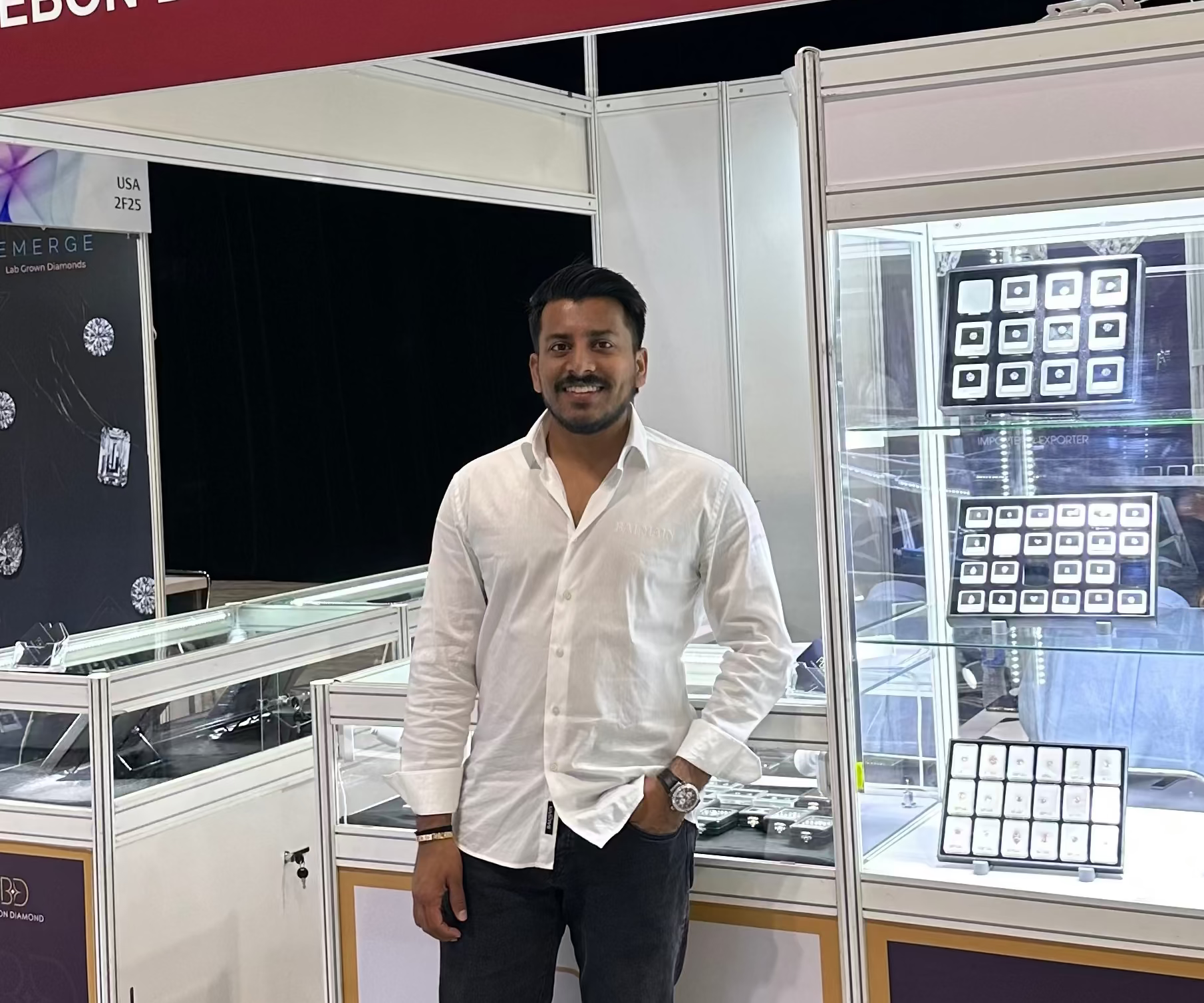 Ankur Radadiya standing in front of a Purebon Diamond LLP booth at an exhibition.