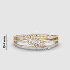 Gold and silver ring with diamond accents on a white background, featuring dimensions and a brand name.