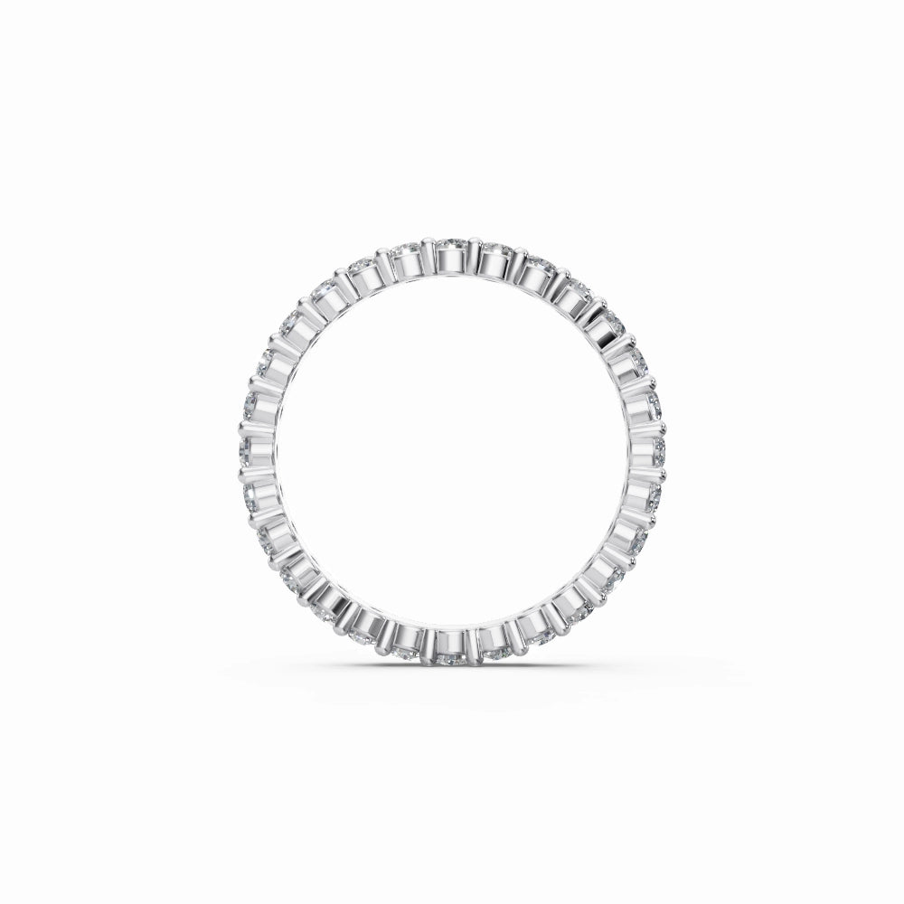 White gold eternity band worn on finger, giving a contemporary, minimal, elegant appearance.