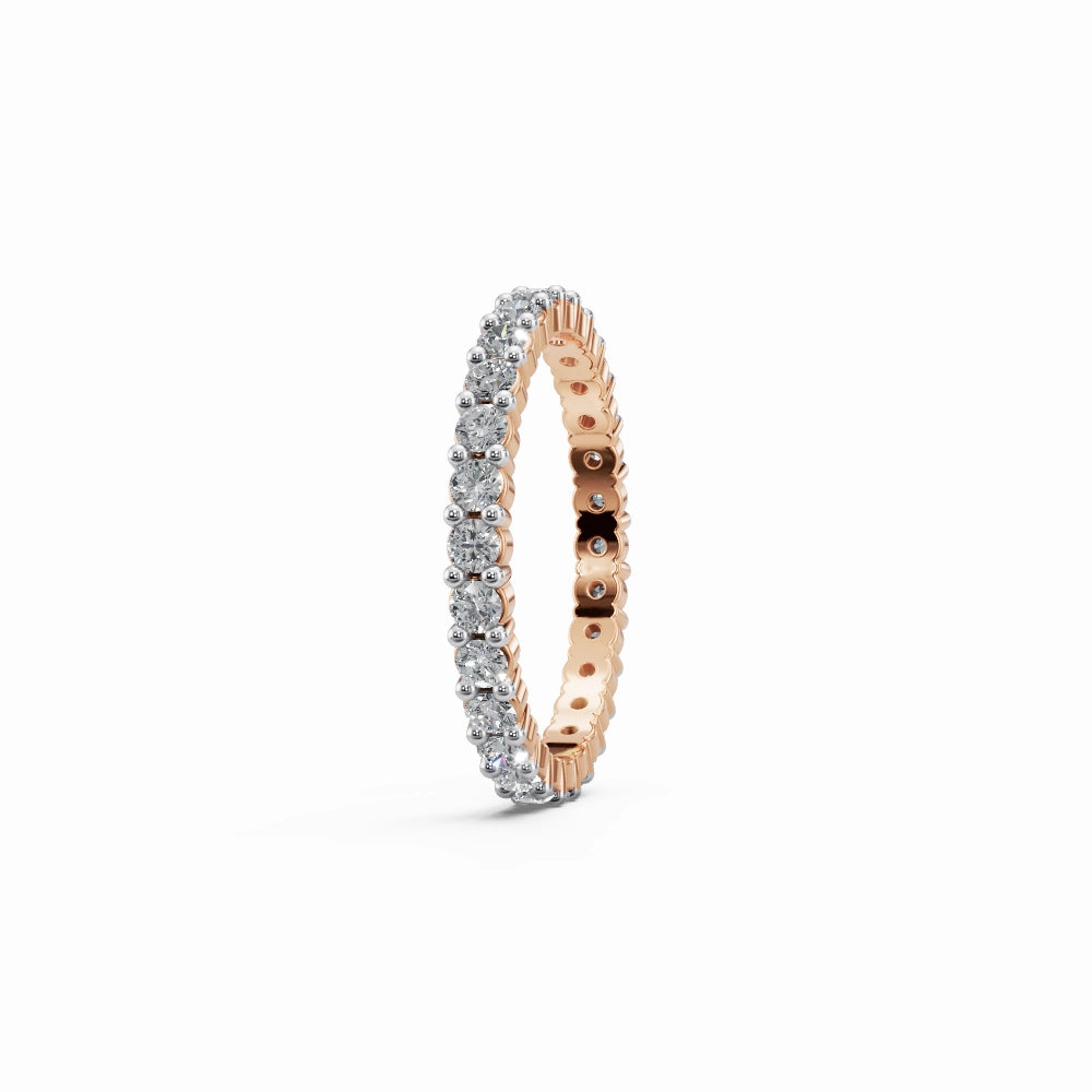 Side profile of a romantic rose gold eternity ring with delicate shared-prong diamond setting.
