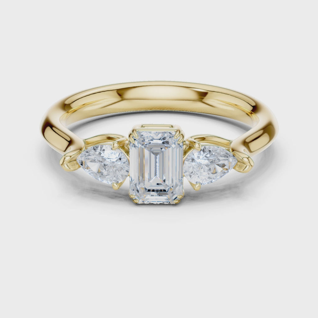 Emerald cut three stone diamond ring