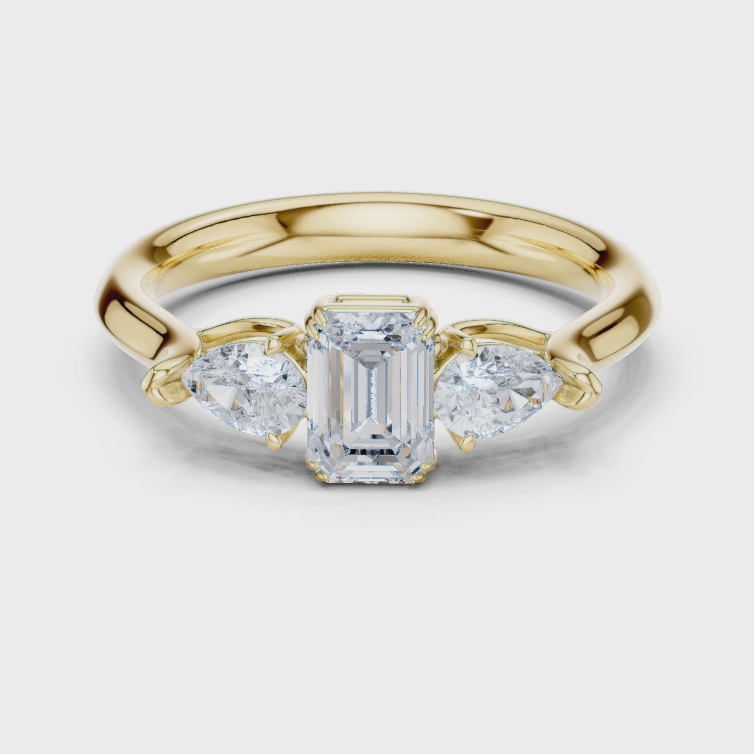 Emerald cut three stone diamond ring
