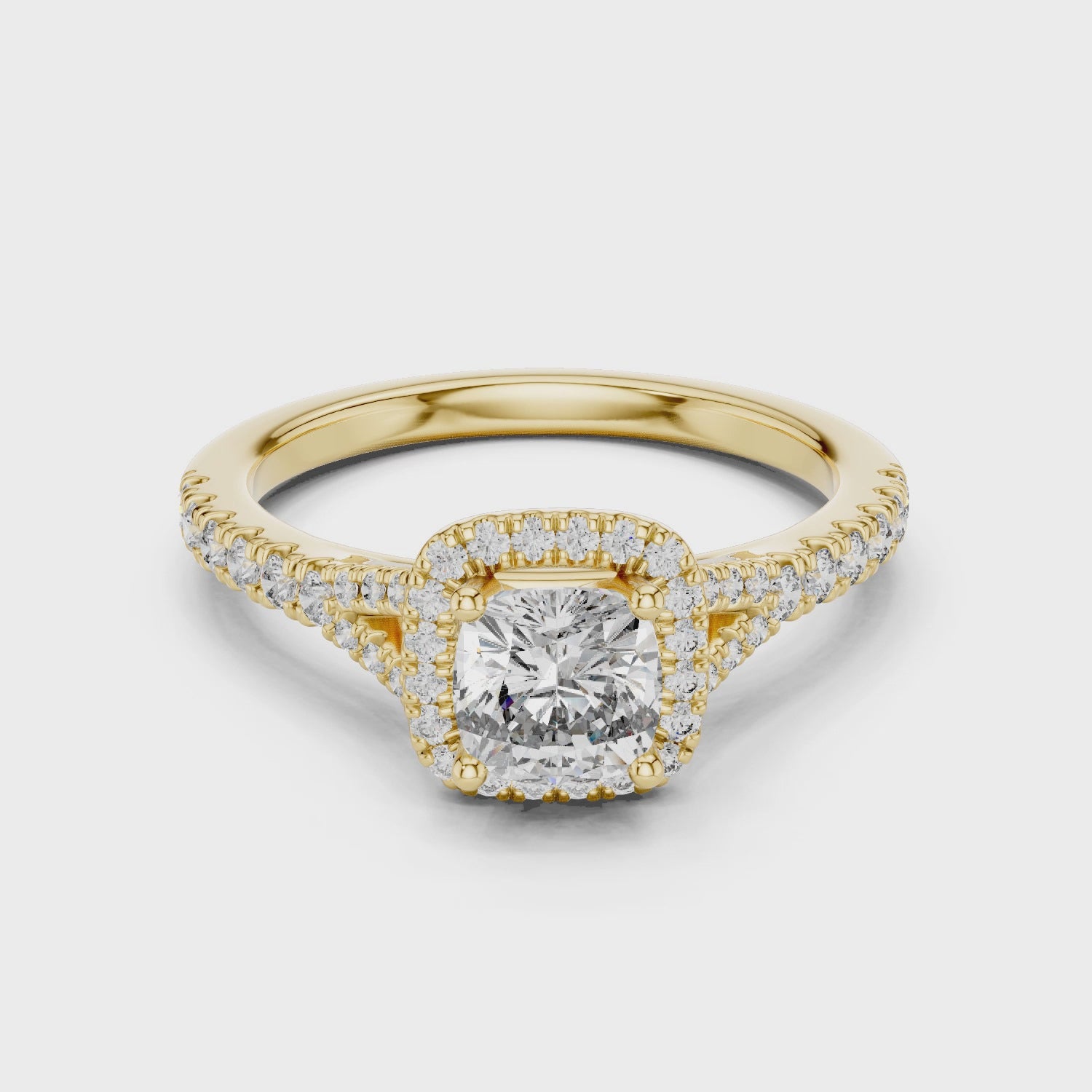 Yellow gold cushion halo solitaire ring with brilliant cushion cut diamond center