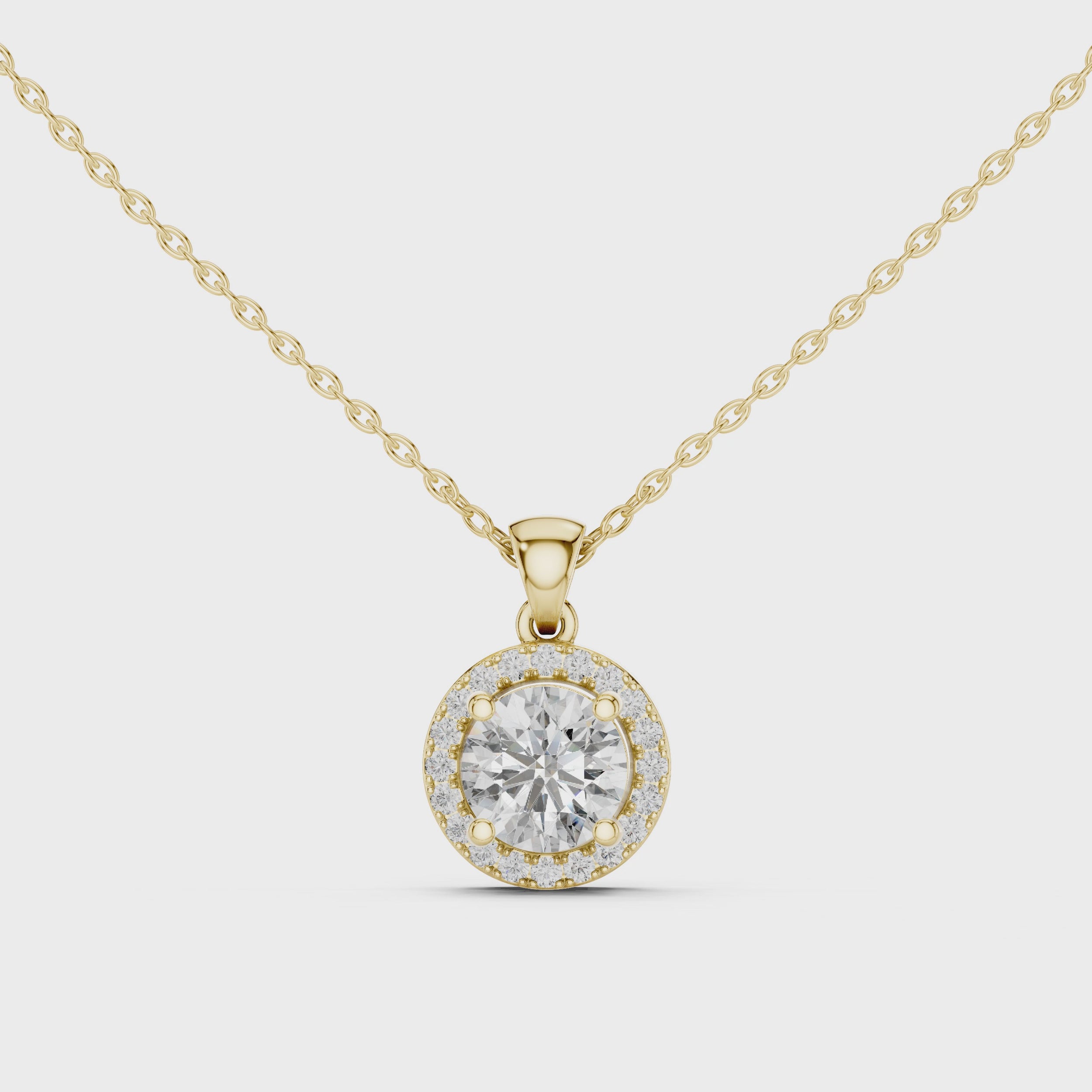 360 degree rotating video of round diamond halo pendant in yellow gold finish
