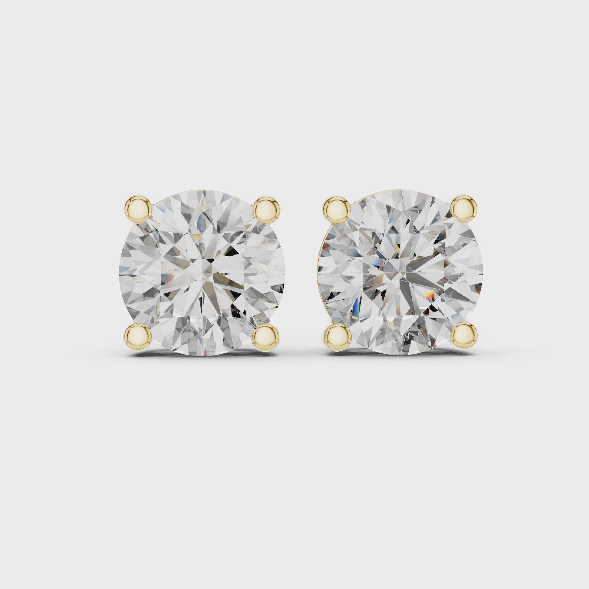 360 degree product video of yellow gold round diamond stud earrings highlighting sparkle, setting details, and overall craftsmanship
