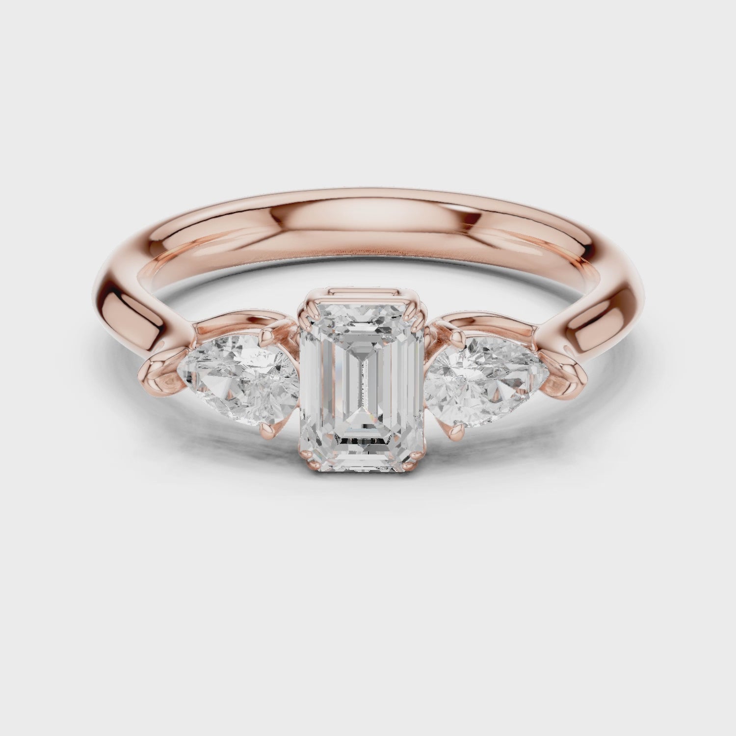 Emerald cut three stone diamond ring
