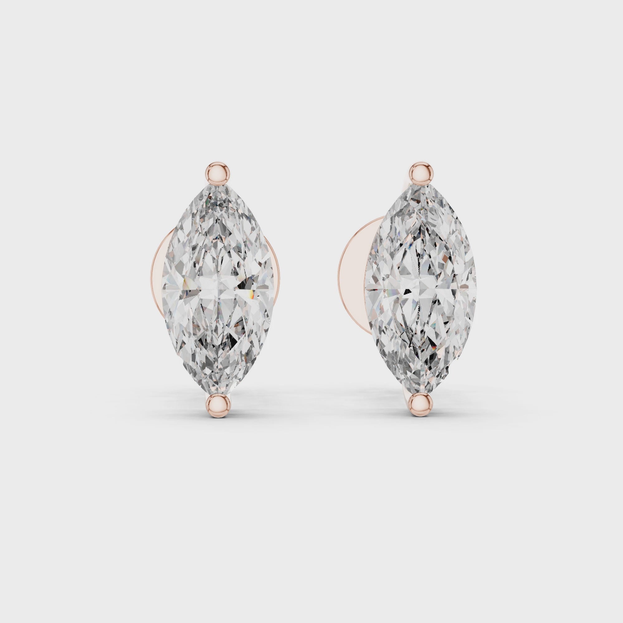 360 degree rotating video of rose gold marquise solitaire diamond stud earrings displaying complete design from every angle