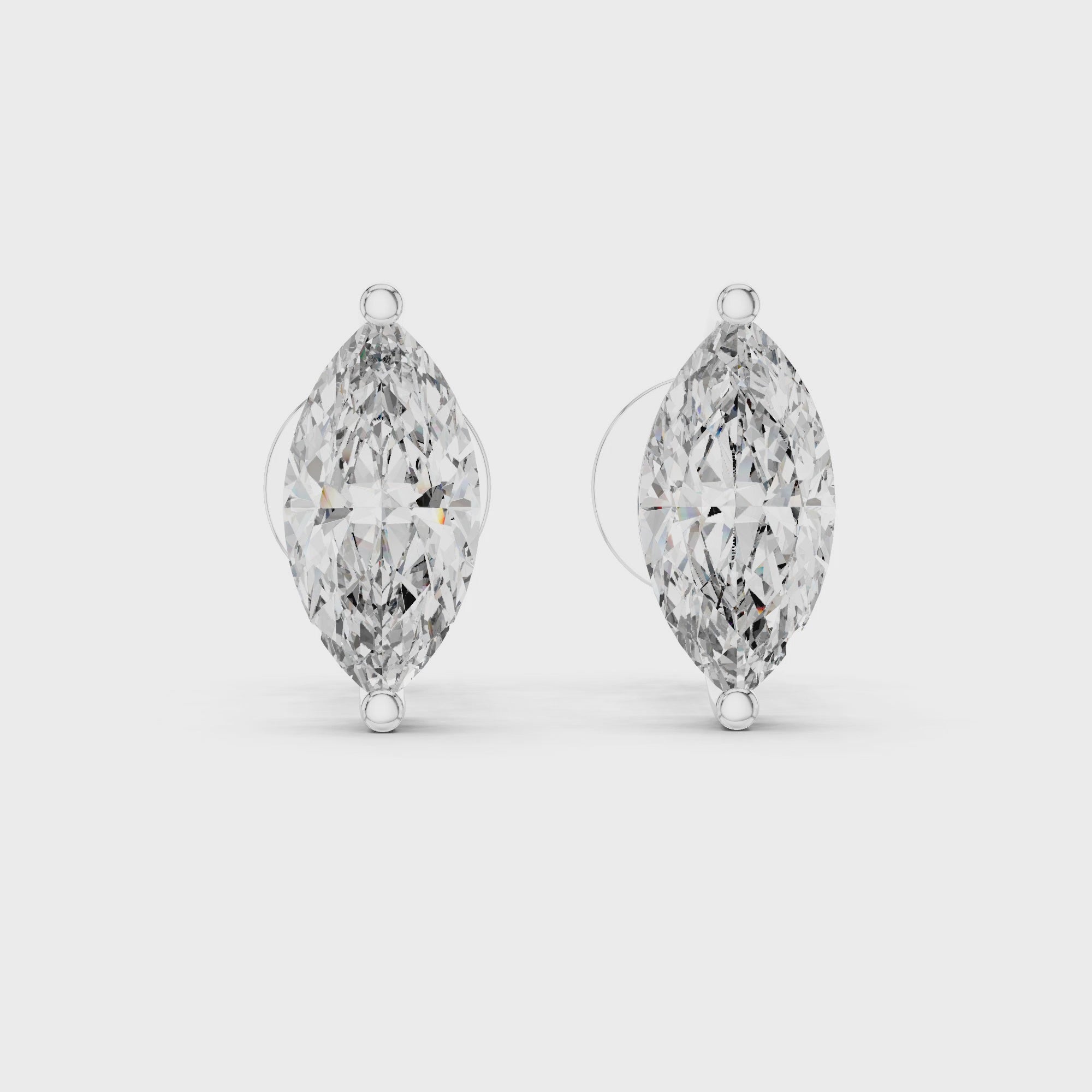 360° rotating view of white gold marquise solitaire stud earrings revealing diamond fire, elegant proportions, and refined polish