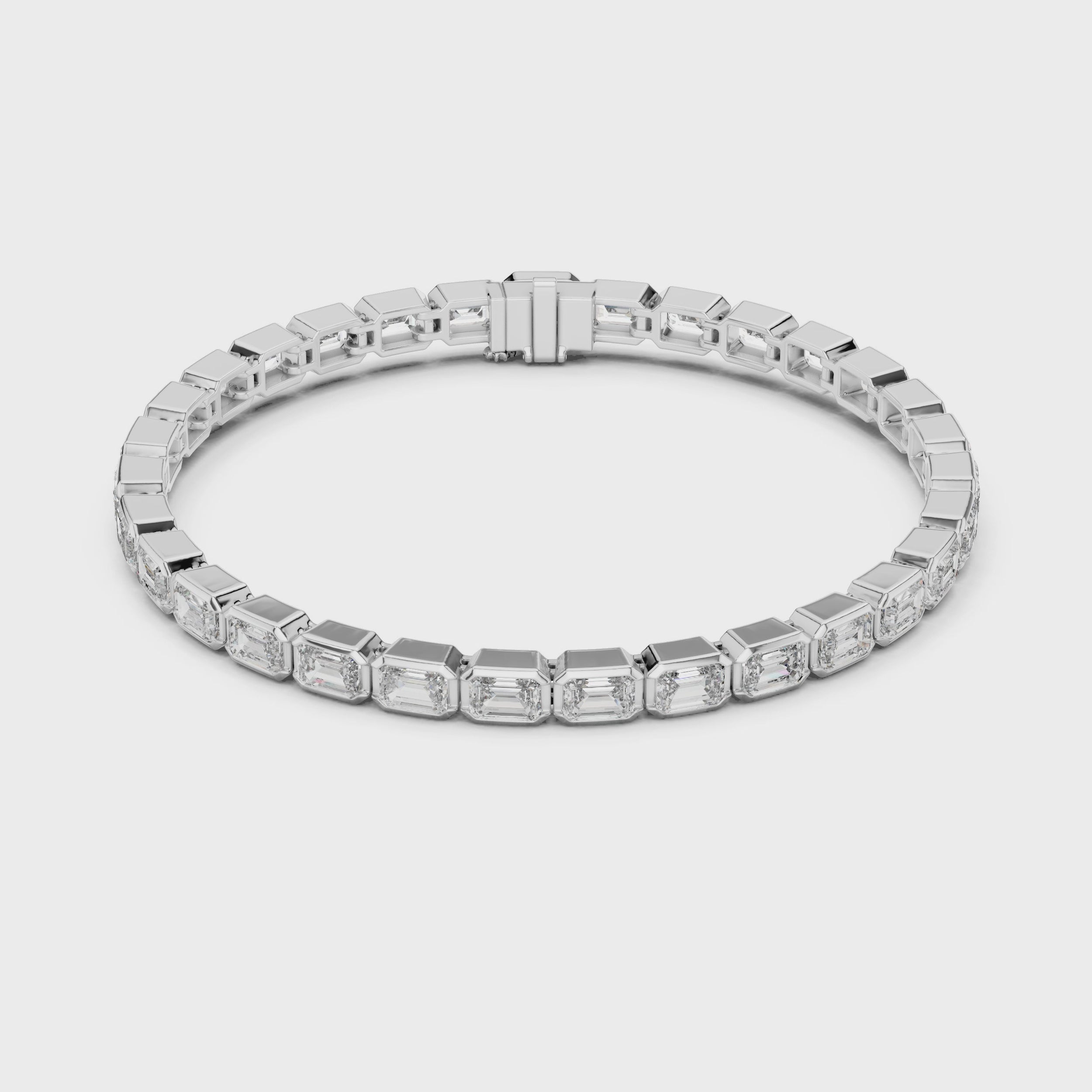 360 degree view video of white gold emerald bezel diamond tennis bracelet displaying full bracelet design and secure clasp