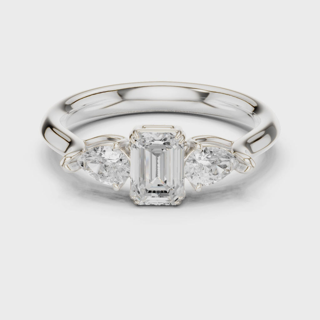 Emerald cut three stone diamond ring