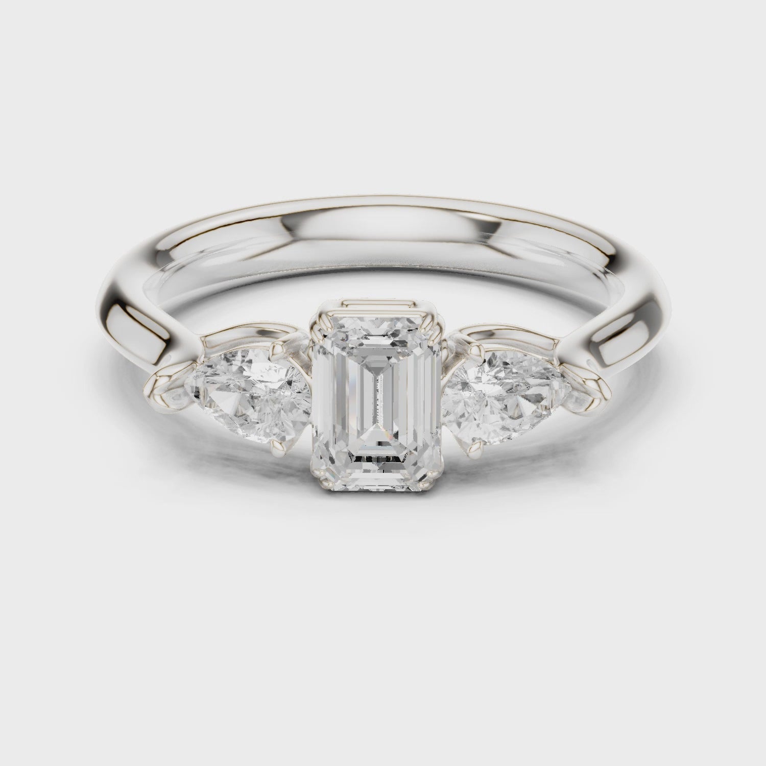 Emerald cut three stone diamond ring